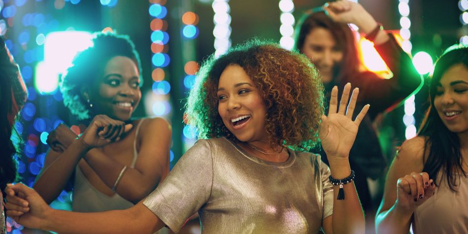 Female friends dancing at party