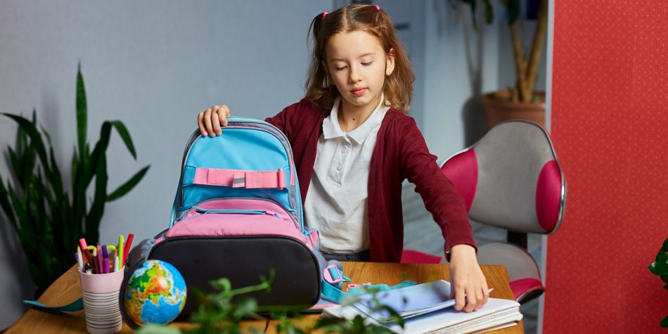 Young school girl with backpack